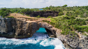 View from above, stunning aerial view of the Broken Beach. Broken Beach locally known as Pantai Pasih Uug is one of the top picturesque and most visited destinations on Nusa Penida Island, Indonesia.